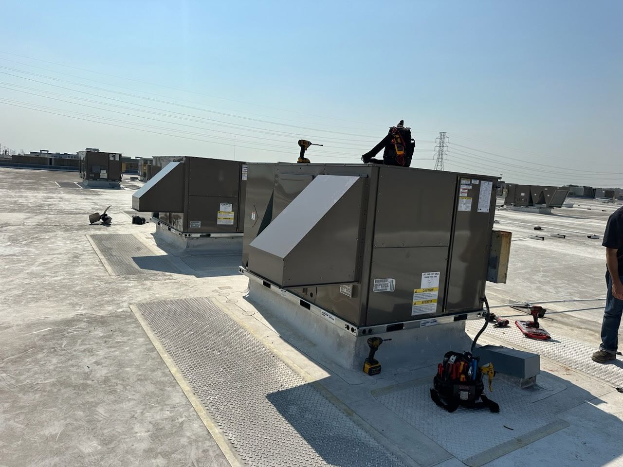 Relm technician servicing commercial rooftop units in Houston